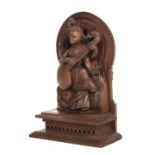 * Deity. An early 20th-century Indian sandalwood carving of a deity