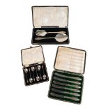 A SET OF CASED SILVER FISH SERVERS,