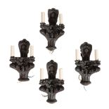 A SET OF FOUR CARVED AND STAINED OAK TWIN LIGHT WALL APPLIQUES, IN GOTHIC STYLE,