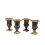 A SET OF FOUR BLACK PAINTED CAST IRON URNS,