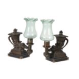 A PAIR OF GEORGE IV PATINATED BRONZE COLZA OIL TABLE LAMPS IN THE FORM OF ANTIQUE RHYTONS,
