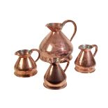 AN ASSOCIATED GROUP OF FOUR VICTORIAN COPPER 'HAYSTACK' WINE MEASURES,