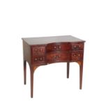 A MAHOGANY CONCAVE FRONT SIDE OR DRESSING TABLE,