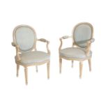 A PAIR OF CARVED, PAINTED AND PARCEL GILT FAUTEUILS IN LOUIS XVI STYLE,