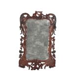 A LATE GEORGE II CARVED WALNUT FRAMED WALL MIRROR, IN ROCOCO STYLE,