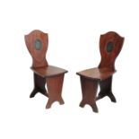 A PAIR OF GEORGE II MAHOGANY HALL CHAIRS, PROBABLY IRISH,