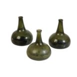 THREE ENGLISH GLASS WINE BOTTLES, EARLY 18TH CENTURY