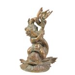 A VICTORIAN BRASS DOOR PORTER CAST AS A PUTTO ON A DOLPHIN,