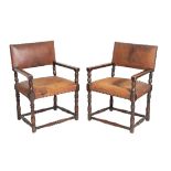 A PAIR OF WALNUT AND LEATHER UPHOLSTERED ELBOW CHAIRS, IN LATE 17TH CENTURY TASTE,