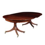 A REGENCY MAHOGANY TWIN PEDESTAL EXTENDING DINING TABLE,