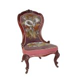 A VICTORIAN CARVED WALNUT AND UPHOLSTERED 'NURSING CHAIR',