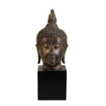 GILT-BRONZE HEAD OF A BUDDHA, THAILAND, 16TH CENTURY OR EARLIER