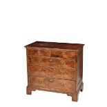 A GEORGE II WALNUT AND FEATHEER BANDED CHEST OF DRAWERS,