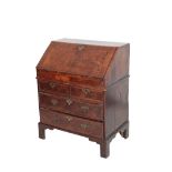 A GEORGE II WALNUT AND CROSSBANDED BUREAU,