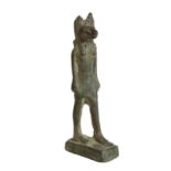 AN EGYPTIAN BRONZE MODEL OF ANUBIS,