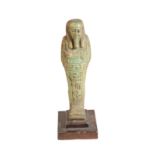 AN EGYPTIAN TURQUOISE GLAZED FAIENCE SHABTI FIGURE,