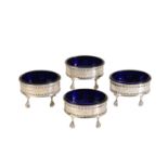 A SET OF FOUR GEORGE III SILVER COLURED METAL SALTS