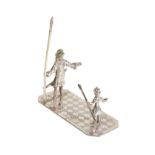 A DUTCH SILVER MINIATURE OF A GUARDSMAN AND CHILD