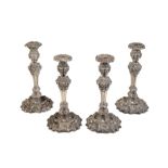 A SET OF FOUR MATCHED GEORGE IV CANDLESTICKS