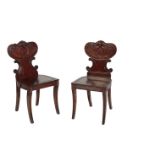 A PAIR OF LATE GEORGE III MAHOGANY HALL CHAIRS,