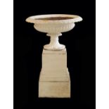 A WHITE PAINTED CAST IRON URN ON PLINTH,