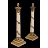 A PAIR OF GILT METAL MOUNTED COLUMN TABLE LAMPS,