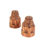 A NEAR PAIR OF VICTORIAN CASTELLATED COPPER 'JELLY' MOULDS,