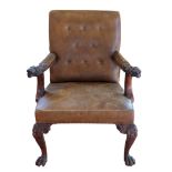 AN IMPRESSIVE GEORGE II STYLE CARVED MAHOGANY AND LEATHER UPHOLSTERED LIBRARY ARMCHAIR