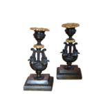 A PAIR OF EMPIRE BRONZE AND ORMOLU CANDLESTICKS