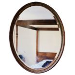 A VICTORIAN GILT COMPOSITION FRAMED OVAL WALL MIRROR,