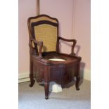 A VICTORIAN MAHOGANY AND CANEWORK COMMODE CHAIR, POSSIBLY BY GILLOWS,