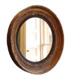 A REGENCY GILTWOOD AND COMPOSITION FRAMED CIRCULAR WALL MIRROR,
