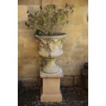 A PAIR OF STONE COMPOSITION GARDEN URNS BY AUSTIN & SEELEY, ON ASSOCIATED PLINTHS,