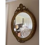 AN EARLY VICTORIAN GILT COMPOSITION FRAMED OVAL WALL MIRROR, IN ROCOCO REVIVAL TASTE,