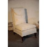 A VICTORIAN UPHOLSTERED LOW CHAIR, IN THE MANNER OF HOWARD & SONS,