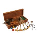 A CASED TABLE CROQUET SET,