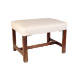 A GEORGE III MAHOGANY AND UPHOLSTERED STOOL,
