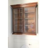 A REGENCY STAINED WOOD AND GLAZED HANGING BOOKCASE,