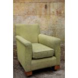 A GREEN UPHOLSTERED ARMCHAIR,