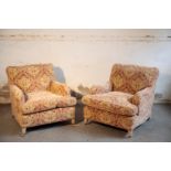 A PAIR OF UPHOLSTERED ARMCHAIRS IN THE MANNER OF HOWARD & SONS,