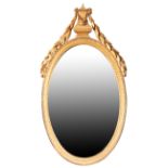 A CARVED AND GILTWOOD FRAMED OVAL WALL MIRROR,