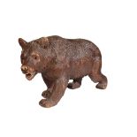 A 'BLACK FOREST' CARVED AND STAINED LINDEN WOOD MODEL OF A BEAR,