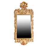 A LATE GEORGE II OR EARLY GEORGE III CARVED AND GILTWOOD FRAMED WALL MIRROR IN ROCOCO STYLE,
