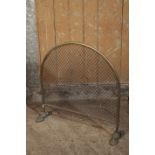 A VICTORIAN GILT METAL AND MESH FIREGUARD