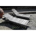 A SET OF FOUR SLATTED TEAK GARDEN RECLINERS,