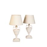 A PAIR OF PAINTED WOOD AND COMPOSITION TABLE LAMPS MODELLED AS TWIN HANDLED URNS,