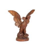 A 'BLACK FOREST' CARVED LINDEN WOOD MODEL OF AN EAGLE,