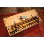 A PINE CASED CROQUET SET,