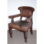 A GEORGE IV OAK AND LEATHER UPHOLSTERED LIBRARY ELBOW CHAIR,
