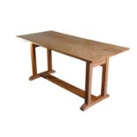 AN OAK TRESTLE TABLE, IN ARTS AND CRAFTS STYLE, POSSIBLY BY HEAL & CO.,